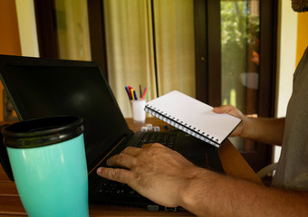 Man doing computer work from home during quarantine. Social Isolation of Office Workers Teleworking During the Pandemic