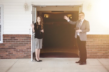 Canvas Print - Male and female church members standing at the church doors
