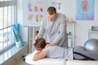 © Pixel-Shot - Massage therapist working with female patient in medical center