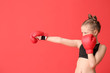 © Pixel-Shot - Little girl in boxing gloves on color background