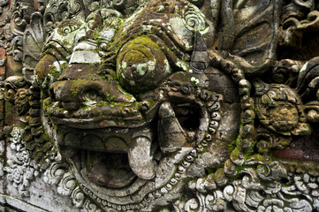 Art sculpture and carved antique deity angel god of hindu statue balinese style in Ubud Palace or Puri Saren Agung historical building complex situated at Gianyar Regency in Bali, Indonesia