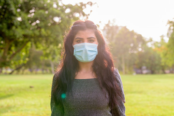 Canvas Print - Young Indian woman with mask for protection from corona virus outbreak at the park