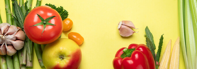 Wall Mural - Fresh fruits and vegetables on yellow background