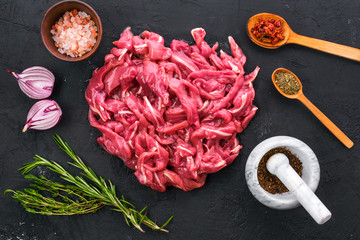 Wall Mural - Top view of raw duck breast on black background