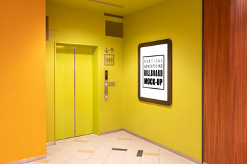 Wall Mural - Mock up vertical signboard on yellow wall near elevator