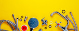 Fototapeta Tulipany - Set of plumbing for bathroom or shower on an yellow background. Flat lay and top view, copy space for text
