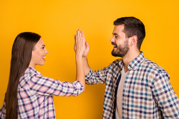 Poster - Profile side photo of excited spouses man woman take party sport match celebrate victory hold hand gesture high five wear good look outfit isolated over bright shine color background