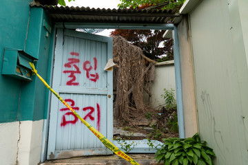 Wall Mural - Seoul's last shanty town. Known as Village 104 it is only half filled with residents who live among empty neighbors waiting for demolition. 