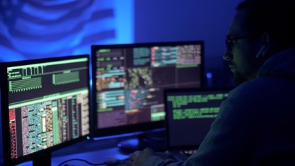 Tired programmer or hacker works at home in quarantine at night. Man thinking in light of the monitor screen. Concept of business assignment job late and working overtime. Internet online job. 