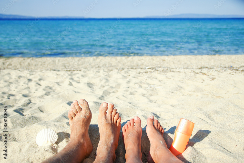 legs of a couple in love on the sand