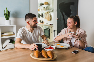 Wall Mural - romantic man and woman couple having breakfast at home