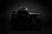 Modern Professional DSLR Camera In Low Key Black Background