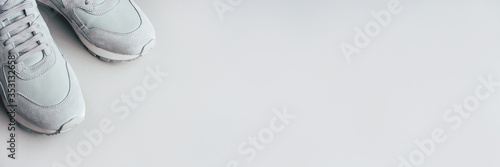 Fotografía Gray sneakers on a gray background