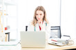 © Masato - Female beautiful wearing a doctor uniform using a notebook computer and talking case of treatment.