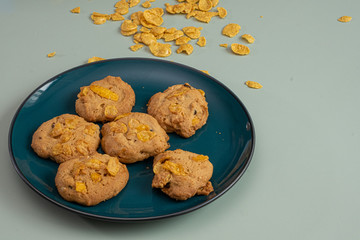 Cookies Corn flakes on light green background