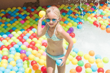 Child on water slide at aquapark. Summer holiday.