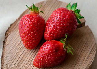 Strawberry close up on wooden background. Sweet, ripe strawberries. Healthy food. A lot of vitamin C of fruits. 