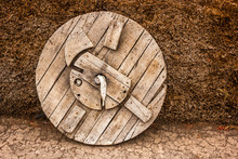 An Old Fashioned Wooden Wheel Beside A Haystack In The Himalayan Village Of Langza In The Spiti Valley In India.