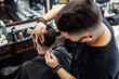 © callisto - Barber makes a haircut and hair styling in a barbershop, beauty salon.