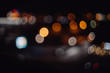 City lights abstract circular lemon bokeh on black background. Defocused takumar lens flares