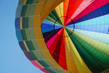 Fototapeta Tęcza - A hot air balloon ride. Colorful air balloon ready for first flight of the day. Flying over Peñafiel, Valladolid, Spain.