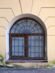 Wall Mural - A basement window with a metal barrier