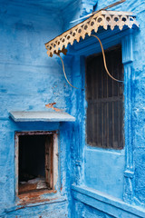 Wall Mural - Windows in blue house facade in streets of of Jodhpur, also known as Blue City due to the vivid blue-painted Brahmin houses, Jodhpur, Rajasthan, India