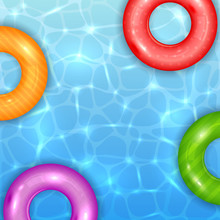 Colored Swim Rings On Water Background