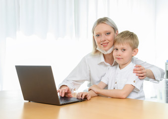 boy child and girl study at a laptop at home.