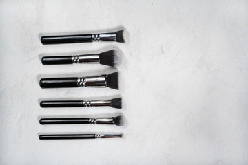 Make up brushes for face on the white background, minimalistic girly flat lay