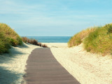 Fototapeta  - North Sea beach with a wooden walkway, North Sea, Norderney Island,Germany