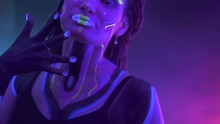 Portrait Of A Girl With Dreadlocks In Neon UF Light. Model Girl With Fluorescent Creative Psychedelic MakeUp, Art Design Of Female Disco Dancer Model In UV, Colorful Abstract Make-Up. Dancing Lady