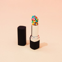 Creative Concept With Lipstick With Colorful Cake Sprinkles. Minimal Make Up Background.
