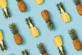 Colorful pattern of pineapples on pastel blue background. Top view. Minimal tropical fruit summer concept.