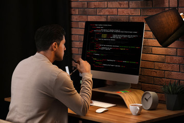 Professional programmer working with computer in office