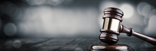 Gavel And Block On Wooden Desk With Bokeh Background - Law And Justice / Auction Concept
