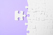 © New Africa - Blank white puzzle pieces on violet background, flat lay