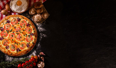 Wall Mural - Brazilian pizza with tomato, cream cheese, olive and basil. Top view on black concrete background, close up. Traditional Brazilian Pizza