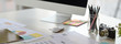 © bongkarn - Cropped shot of UI developer workspace with computer, stationery and paperwork