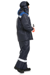  Male model in protective warm suit with hat and wrench in hands in studio