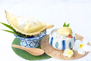 Sweet Sticky Rice With Durian And Coconut Milk Sauce,Thai sweet sticky rice with durian, Thai style tropical dessert,  isolated on white background, selective focus.