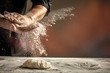 Photo of flour and men hands with flour splash. Cooking bread. Kneading the Dough