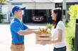 © Kiattisak - Food Deliver Asian man in blue uniform give fruit and vegetable to receiver customer front house, fast express grocery service when crisis coronavirus, covid19 new normal lifestyle concept.
