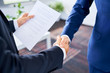 © baranq - Closeup of two businessman shaking hands after successful job interview