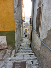 Sticker - Detail of narrow street and stone steps in the ancient town of Matera (Sassi di Matera), European Capital of Culture 2019,and UNESCO Heritage  site and clouds, Basilicata Italy  