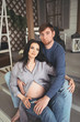© Алина Троева - Pregnancy and people concept - happy man hugging his beautiful pregnant wife at home. Future parents waiting unborn baby. Love, relationship, birth, happy family concept - young lovely married couple
