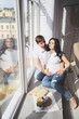 © Алина Троева - Pregnancy and people concept - happy man hugging his beautiful pregnant wife at home. Future parents waiting unborn baby. Love, relationship, birth, happy family concept - young lovely married couple
