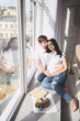 © Алина Троева - Pregnancy and people concept - happy man hugging his beautiful pregnant wife at home. Future parents waiting unborn baby. Love, relationship, birth, happy family concept - young lovely married couple