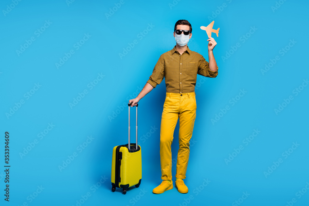 Full length body size view of nice guy wearing gauze mask gumshoes traveling abroad airplane open border quarantine enjoy business class isolated bright vivid shine vibrant blue color background - obrazy, fototapety, plakaty 