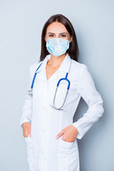 Wall Mural - Portrait of pretty female doctor crossed hands wear medical safety sterile mask on face, pandemic corona virus prevention protection concept 2020 covid19